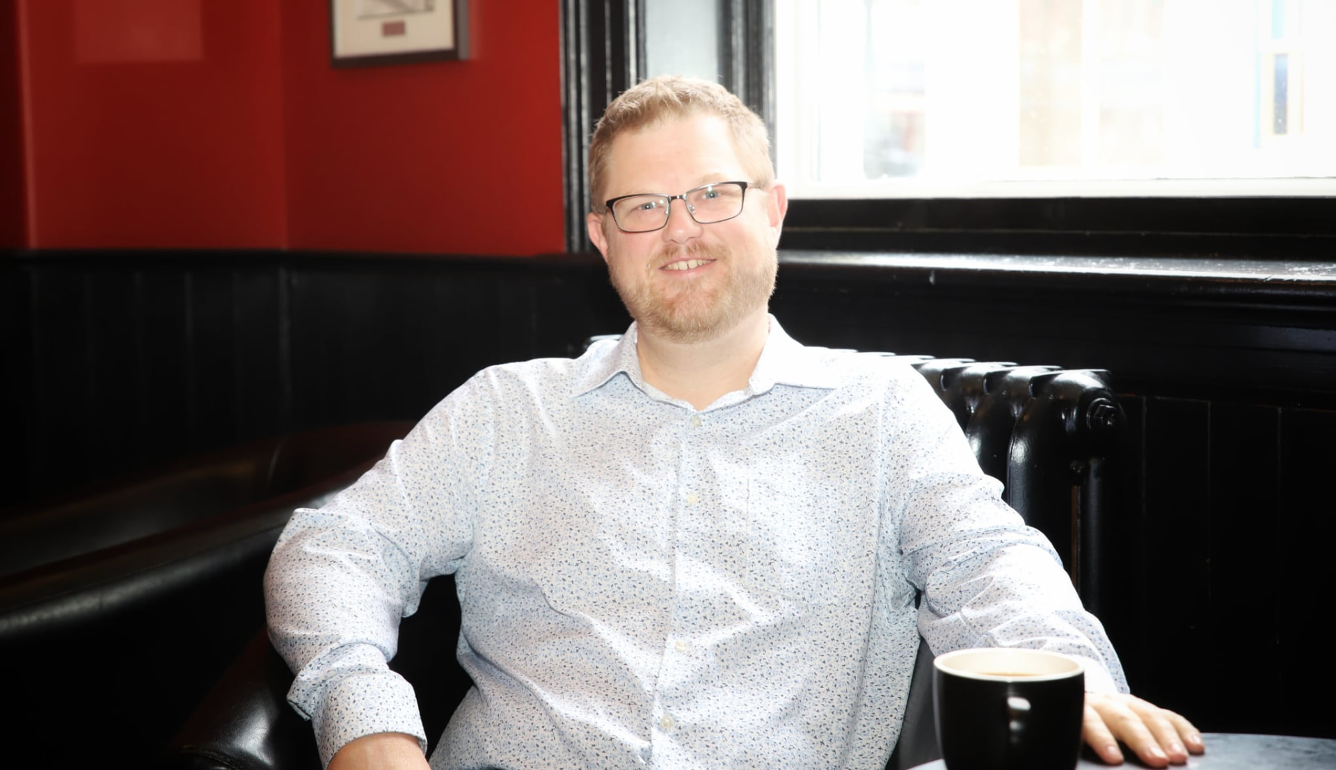 Brad Way, FlexBEN founder, seated with a coffee